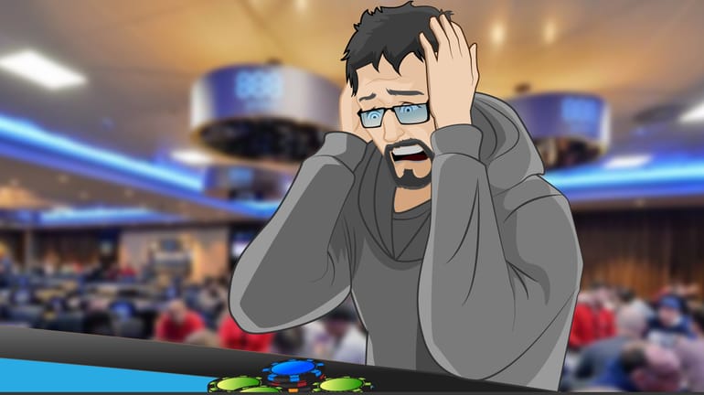 Poker player holding head in hands