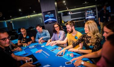 9 players at a poker table with three of them crossed out