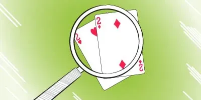 MAGNIFYING GLASS OVER POCKET DEUCES HAND